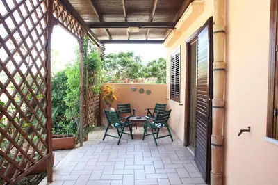 a patio with a table and chairs on it at Acquamarina32 in San Vito lo Capo
