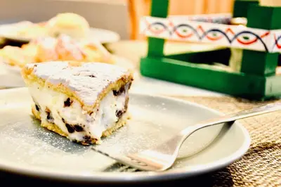 a piece of cake on a plate with a fork at B&B L'Orlando Furioso in Palermo