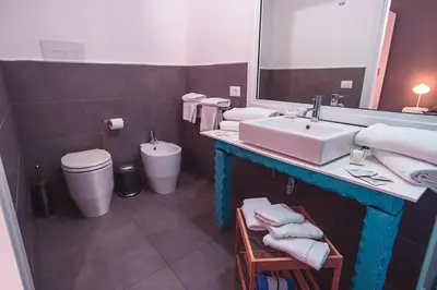 a bathroom with a sink and a toilet and a mirror at B&B L'Orlando Furioso in Palermo