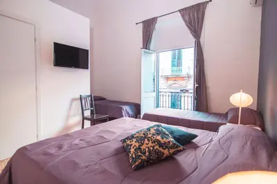 a bedroom with a large bed and a window at B&B L'Orlando Furioso in Palermo
