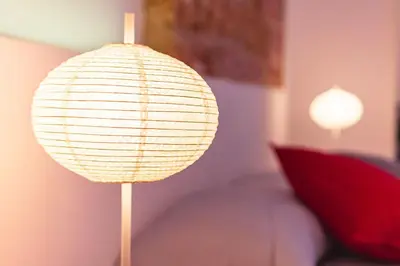 a lamp in a room with a red pillow at B&B L'Orlando Furioso in Palermo
