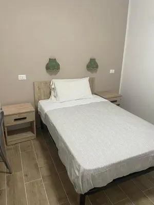 a bed in a room with two nightstands and a bed sidx sidx sidx at Hotel Cortese in Palermo