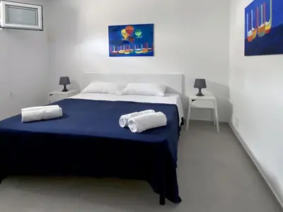 a bedroom with a bed with two towels on it at Maresole apartments - direttamente sul mare in Alcamo Marina