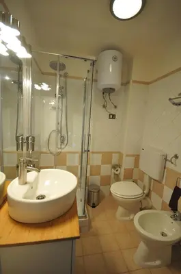 a bathroom with a sink and a shower and a toilet at Papireto 11 Loft in Palermo