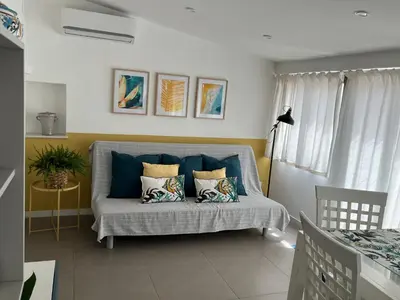 a living room with a couch with pillows at Fiori d'Arancio in Terrasini