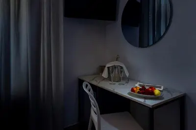 a bed in a room with a couch in it at Sun Garden in San Vito lo Capo