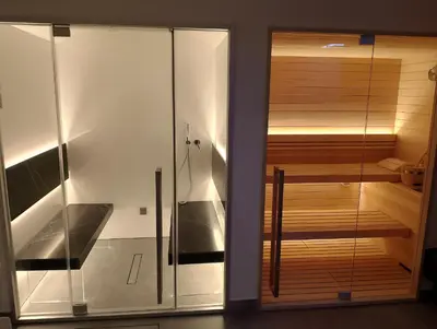 a sauna with a glass door in a room at Ville dell'Eden con 9 camere da letto in 6 unità abitative in Lascari