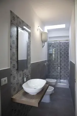 a bathroom with a sink and a toilet and a shower at Ville dell'Eden con 9 camere da letto in 6 unità abitative in Lascari