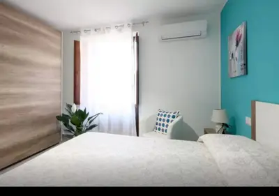 a bedroom with a white bed and a window at Rainbow in Castellammare del Golfo