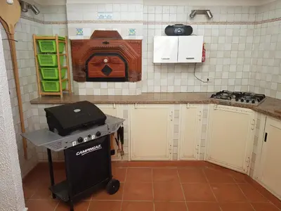 a kitchen with a stove top oven in a room at Villa del Golfo Urio with swimming pool shared by the two apartments it is essential to have a car in Santa Flavia