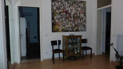 a room with two chairs and a painting on the wall at Bobnb in Palermo
