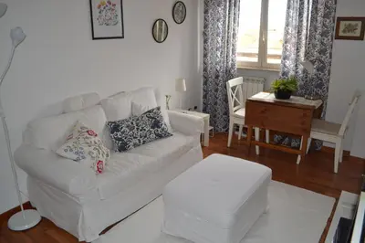 a living room with a white couch and a table at Appartamento Alla Zisa in Palermo