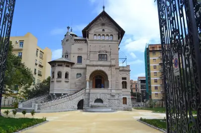an old building with a tower in a city at Appartamento Alla Zisa in Palermo
