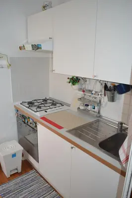a small kitchen with a stove and a sink at Appartamento Alla Zisa in Palermo