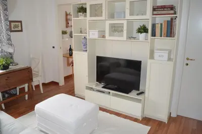 a living room with a tv in a white book shelf at Appartamento Alla Zisa in Palermo