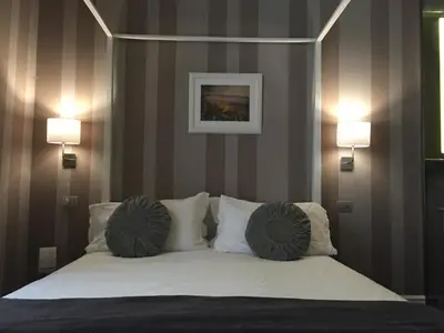 a bedroom with a bed with two pillows on it at 29 Venti Luxury in Palermo