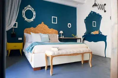 a bedroom with a large bed with blue walls at Curù in Castellammare del Golfo