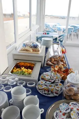 a buffet of food on a table with plates and dishes at Pharos in San Vito lo Capo