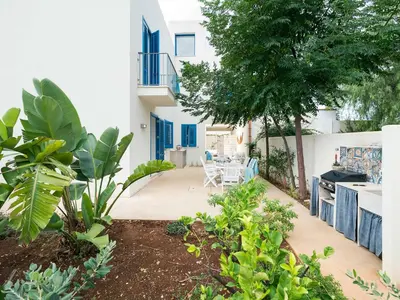 a garden with a patio and a house at Lisca Bianca in San Vito lo Capo
