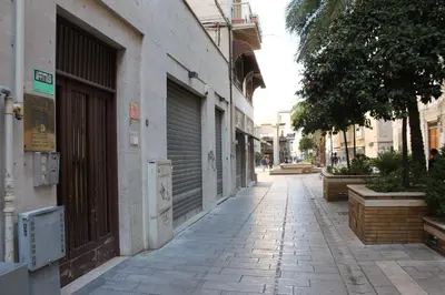an empty street in a city with a building at B&B Casa Rosellina in Palermo