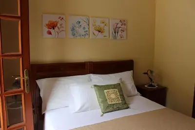 a bedroom with a bed with a pillow on it at Raggio di Sole Bed & Breakfast in Macari