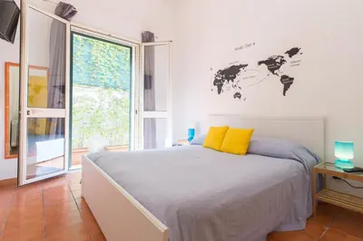 a bedroom with a bed with a world map on the wall at Villa Mondello in Mondello