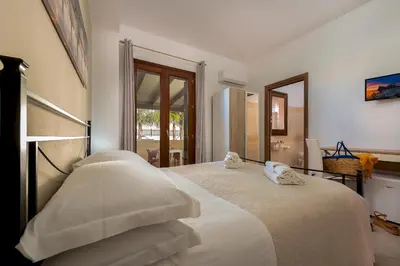 a bedroom with a bed with two pillows on it at Samira in San Vito lo Capo