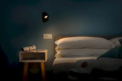a bedroom with a bed and a night stand with a phone at Samira in San Vito lo Capo