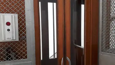 a wooden door with a red light and a window at Profumo di Sicilia in Palermo