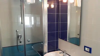 a bathroom with a shower and a sink and a mirror at Profumo di Sicilia in Palermo