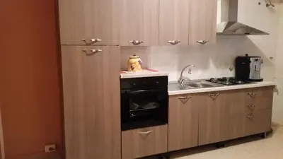 a small kitchen with a stove and a sink at Profumo di Sicilia in Palermo