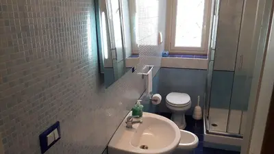 a small bathroom with a sink and a toilet at Profumo di Sicilia in Palermo