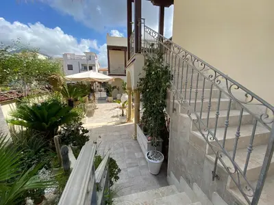 a stairway with potted plants on the side of a building at RIAD Comfort Rooms in San Vito lo Capo