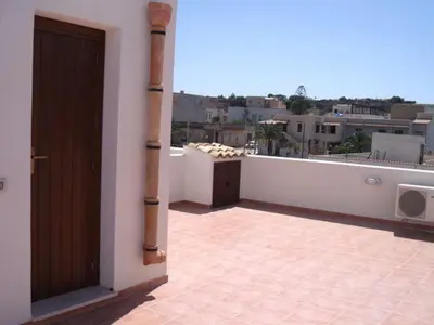 an open door on a balcony of a building at Case nel Giardino in San Vito lo Capo