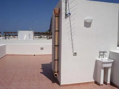 a bathroom with a toilet on the side of a building at Case nel Giardino in San Vito lo Capo