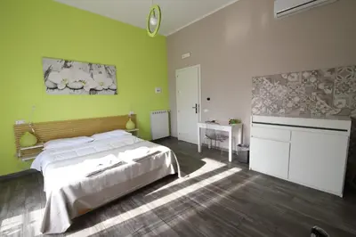 a bedroom with a bed and a sink and a desk at Le Cupole Design in Palermo