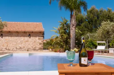 a swimming pool in a villa with mountains in the background at Villa Le Sterlizie in Castellammare del Golfo