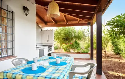 a group of trees in front of a house at Villa Le Sterlizie in Castellammare del Golfo
