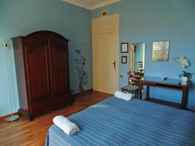 a bedroom with a bed with two towels on it at Kemonia in Palermo