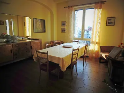 a dining room with a table and chairs and a window at Kemonia in Palermo