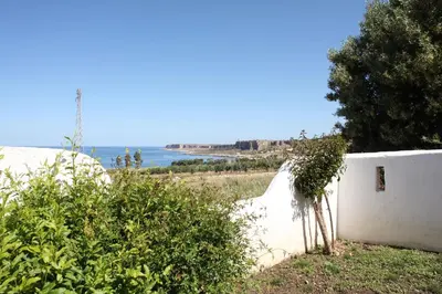 a white wall with a view of the ocean at Country Villa San Vito Bay in San Vito lo Capo