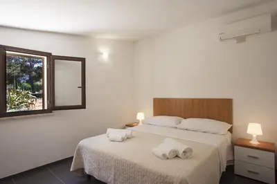 a bedroom with two towels on a bed at Villetta Blusanvito in San Vito lo Capo