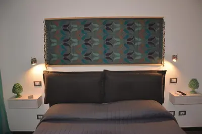 a bedroom with a bed with a tapestry above it at Duca di Villena in Palermo