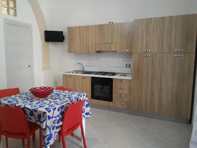 a kitchen with a table with a table cloth on it at I due Archi in Castellammare del Golfo
