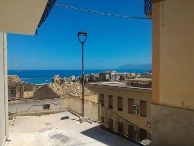 a view of the ocean from a building with a street light at I due Archi in Castellammare del Golfo