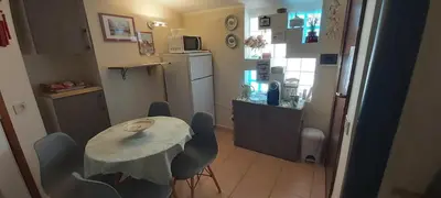 a small kitchen with a table and a refrigerator at La perla della Conca d'Oro in Palermo