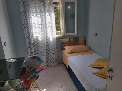 a small bedroom with a bed and a window at La perla della Conca d'Oro in Palermo