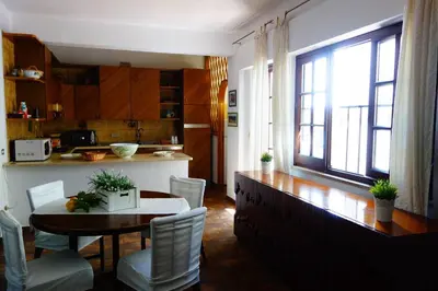 a kitchen and dining room with a table and chairs at Villa Maria in Mondello