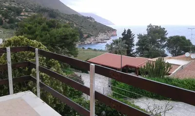 a view of the ocean from the balcony of a house at Two Steps From The Sea in Scopello