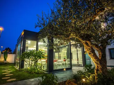 a glass house with a tree in front of it at Tra Le Braccia di Morfeo in Terrasini